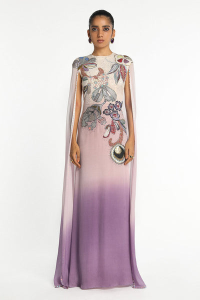 Woman wearing Kinfolk mist purple ombre chiffon gown with cape