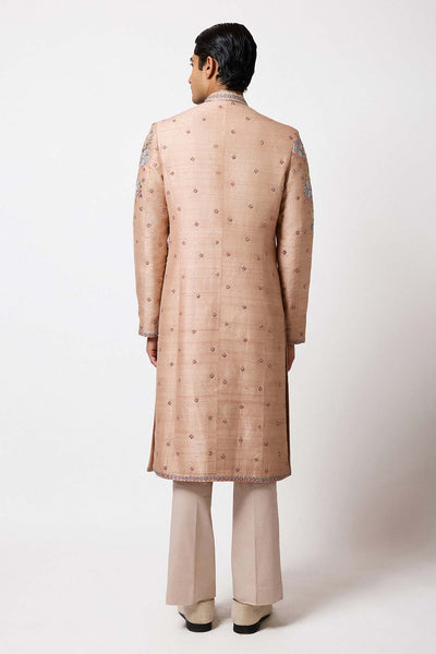 Rear view of champagne raw silk sherwani by Aisha Rao