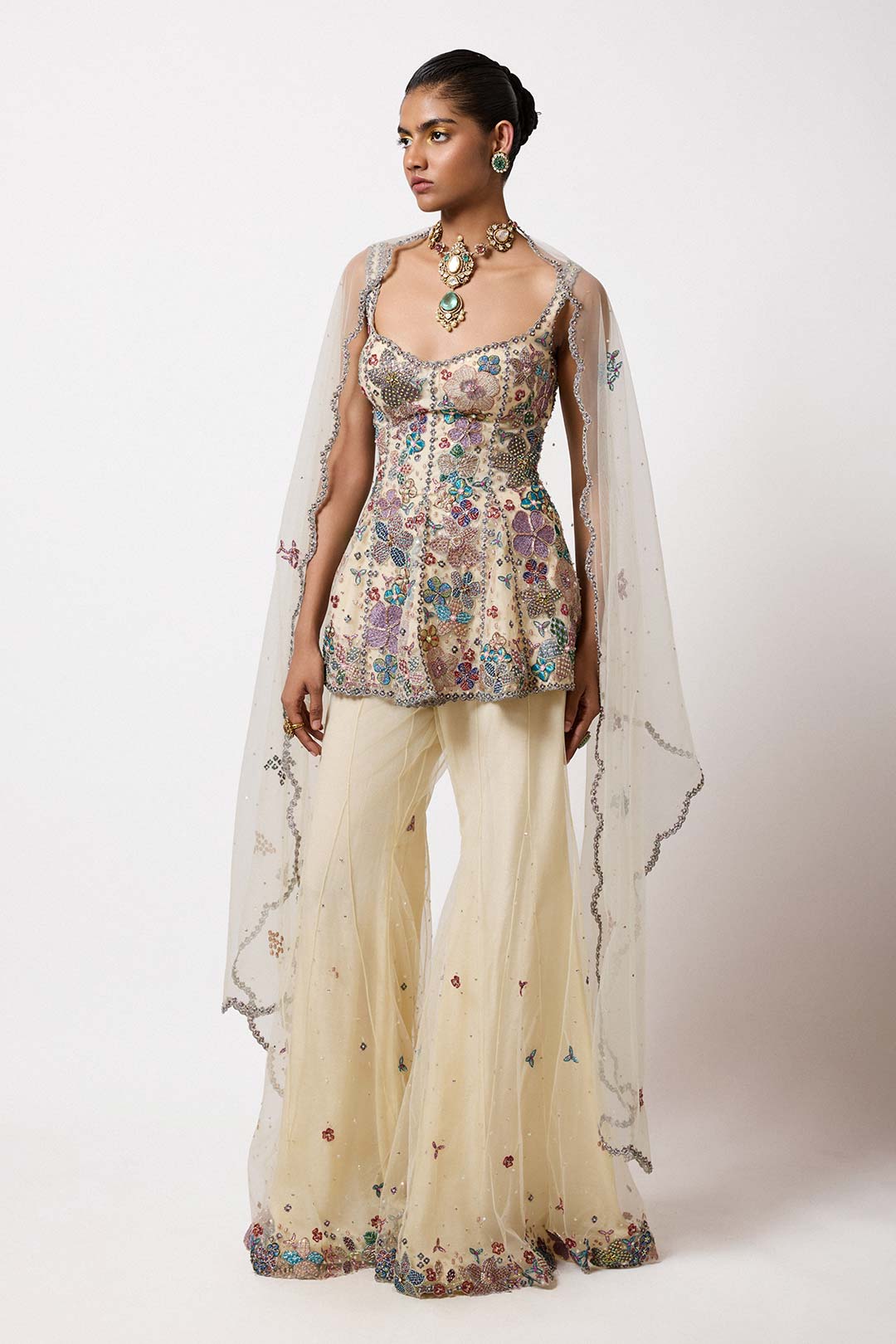 Woman in short net kurta with applique left profile