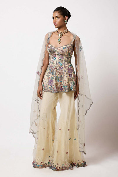 Woman in short net kurta with applique left profile