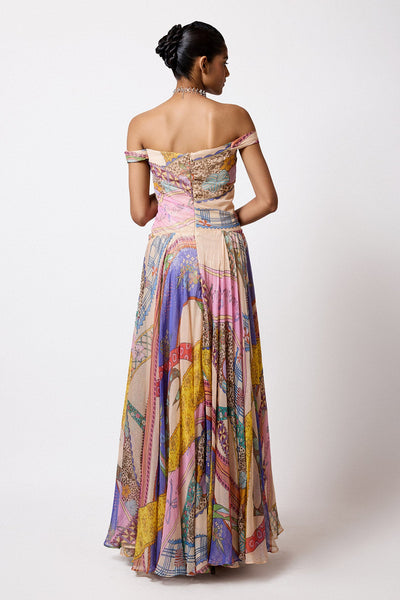 Woman in Aisha Rao ribbon print lurex dress back view