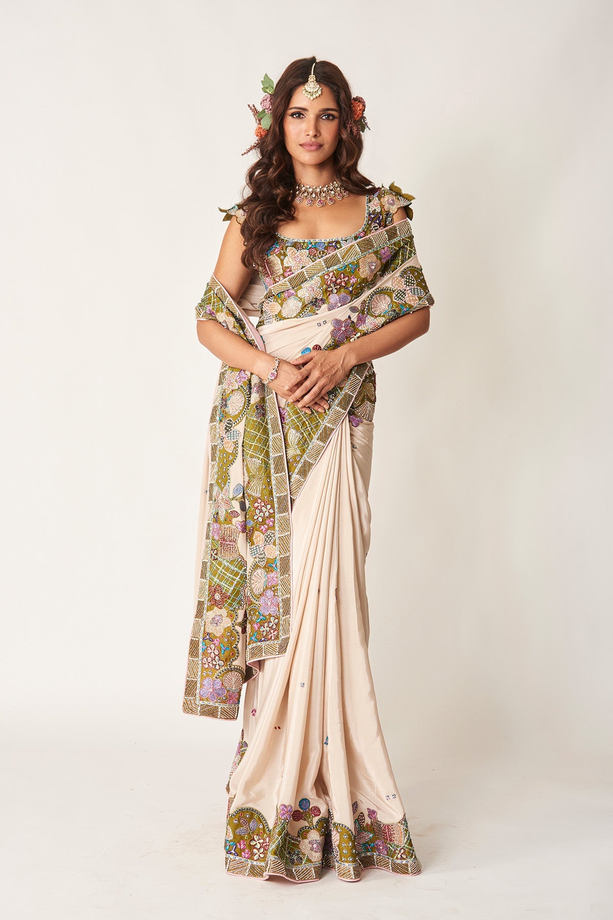 Woman wearing ivory olive applique saree