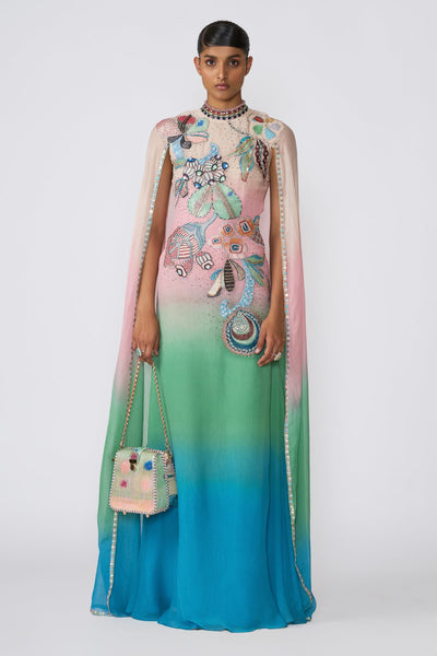 Woman wearing Kinfolk aurora ombre chiffon gown with cape