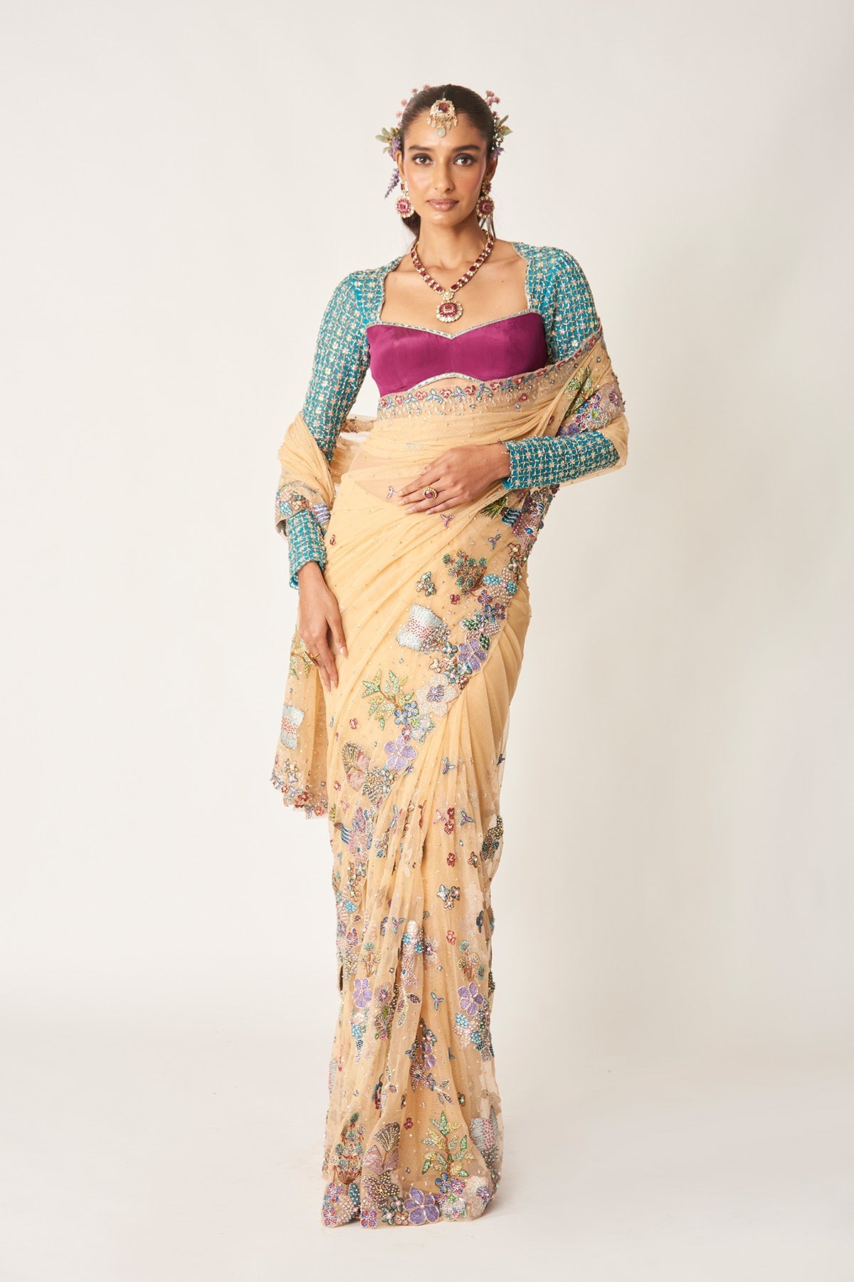 Woman in bisque tulle saree with full-sleeve blouse