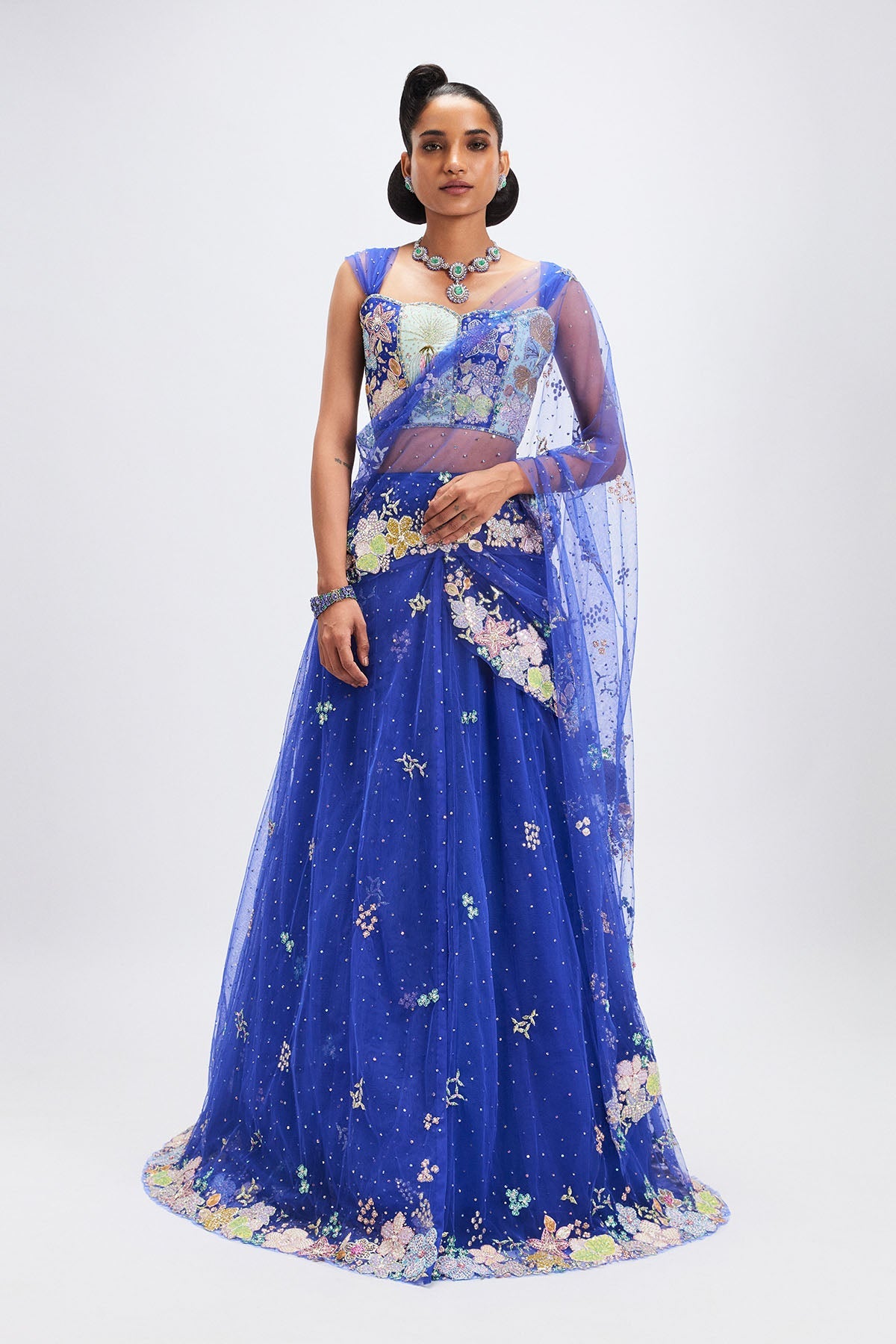 Woman wearing Persian blue stitched saree lehenga