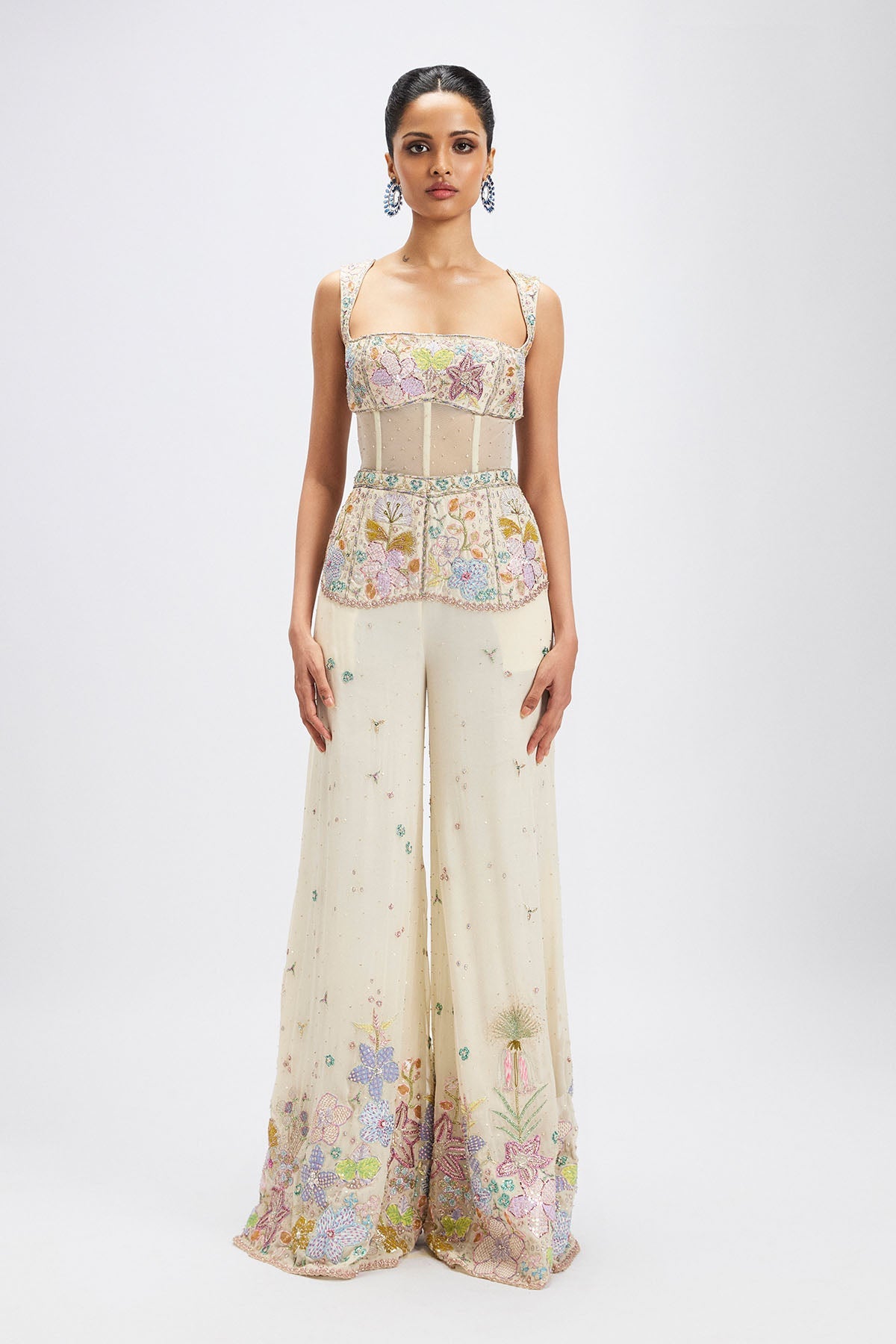 Woman wearing ivory applique embellished jumpsuit