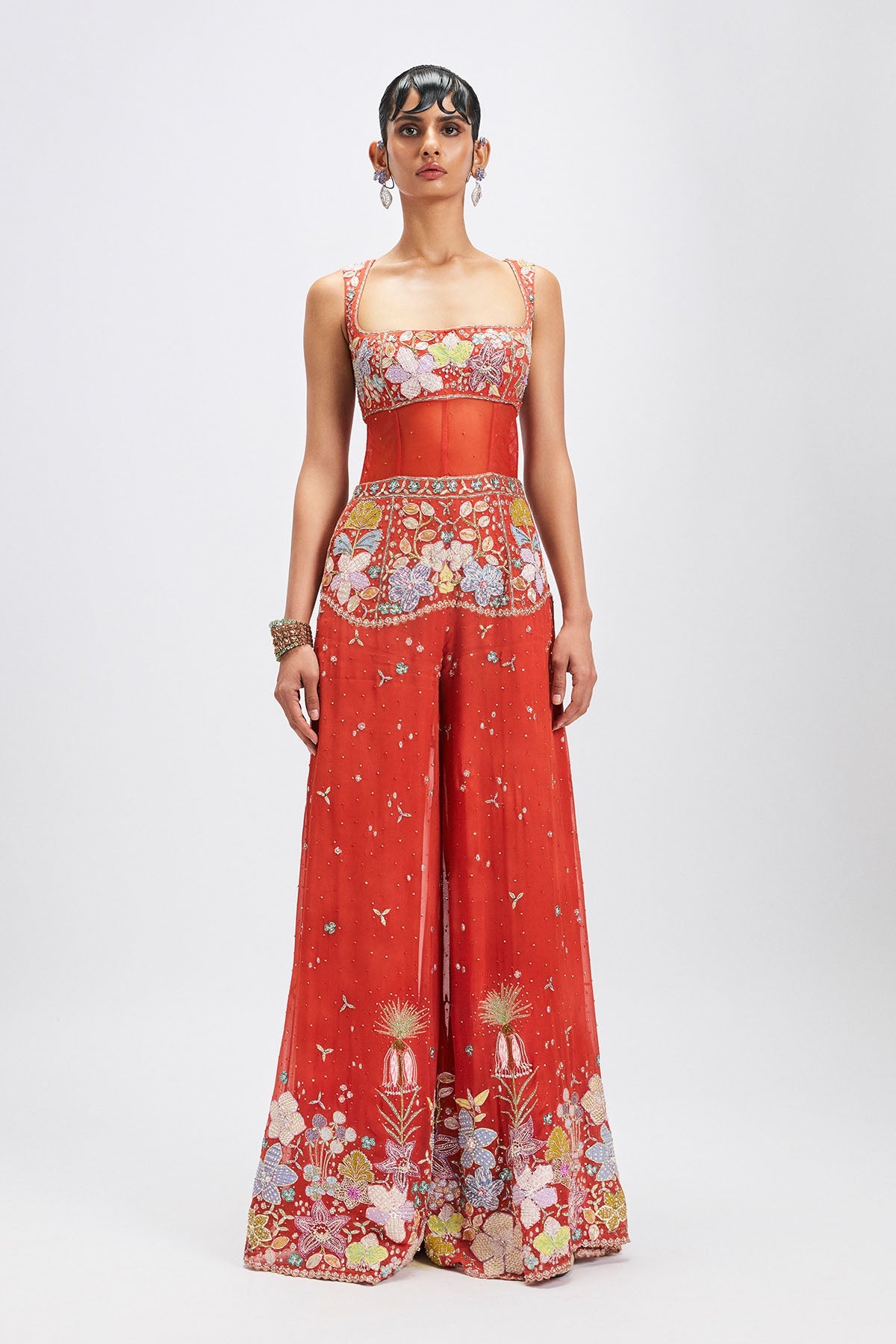 Woman wearing orange applique embellished jumpsuit