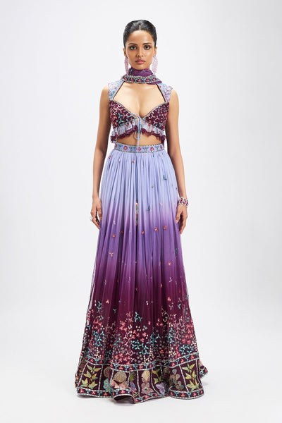 Woman wearing plum-dusk blue embellished lehenga set