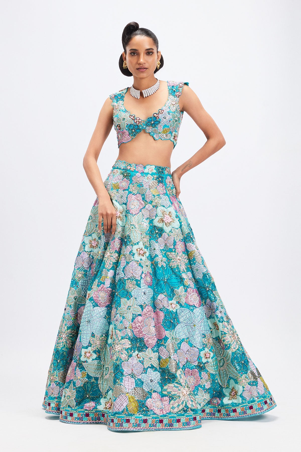 Woman in cyan blue floral applique lehenga