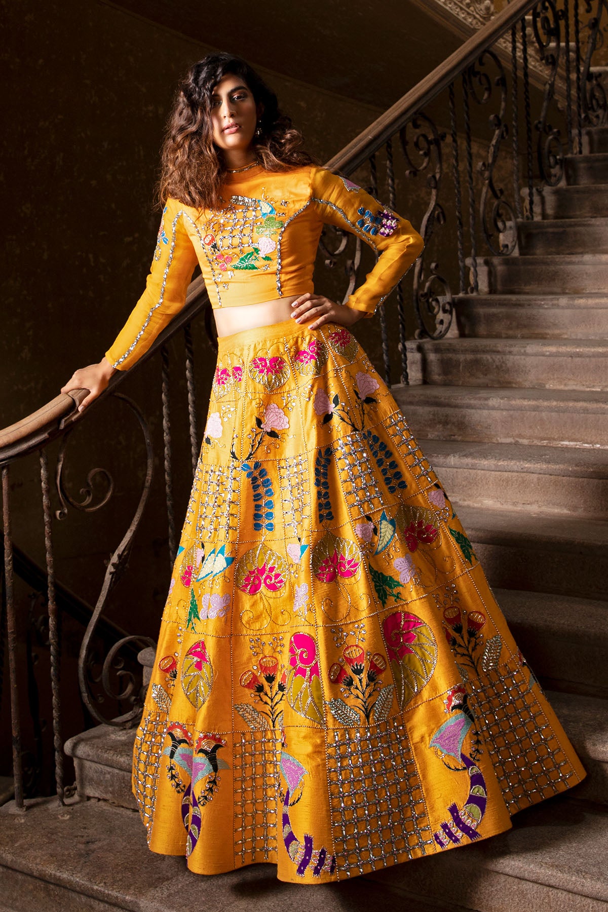 Woman wearing amber yellow raw silk lehenga
