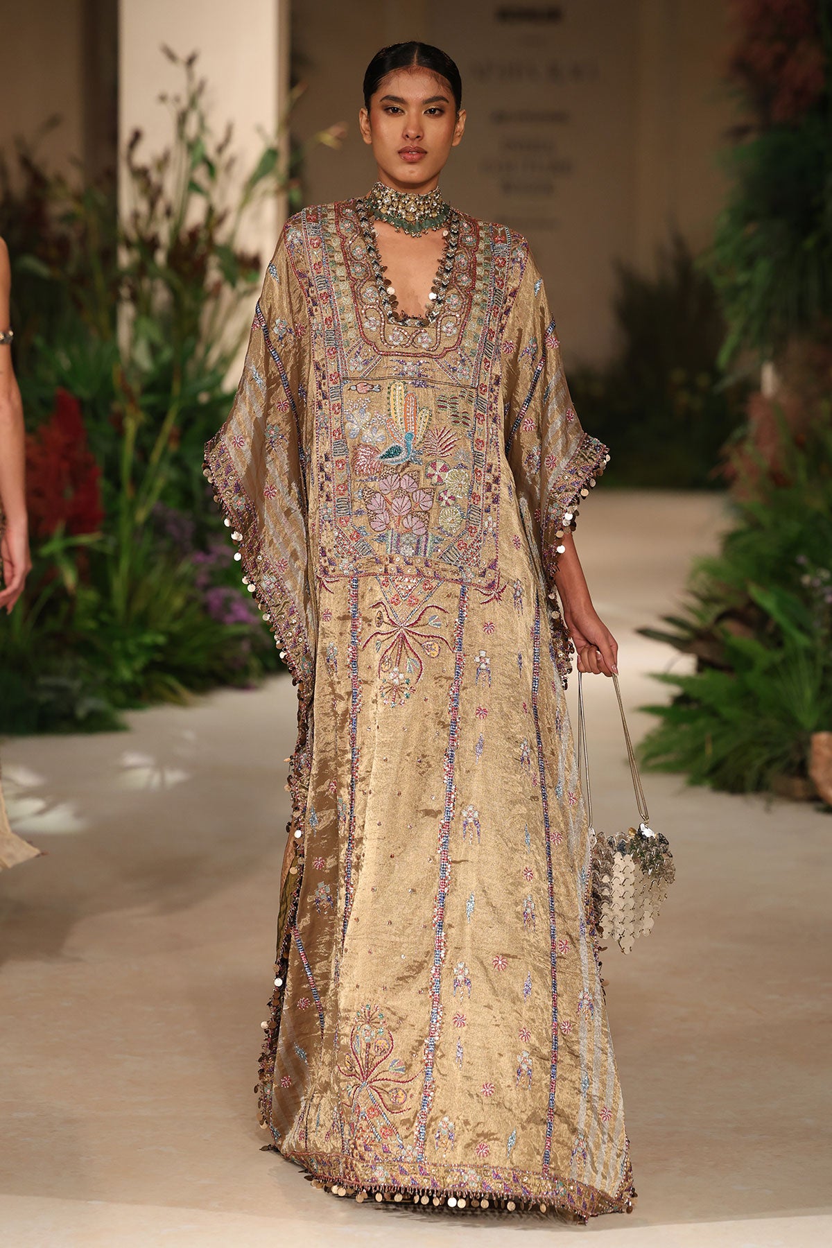 Neckline detail featuring applique artistry and embellished refinement from the Wild At Heart golden kaftan
