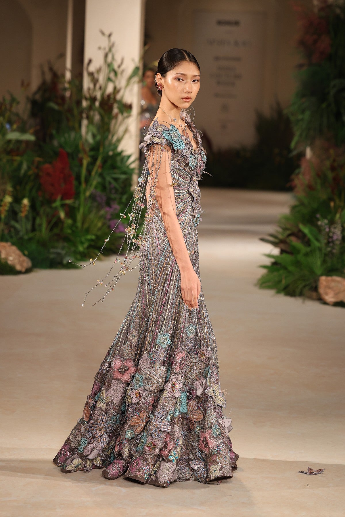 Closeup of the 3D floral appliqué crafted on the grey organza surface with embellished finesse