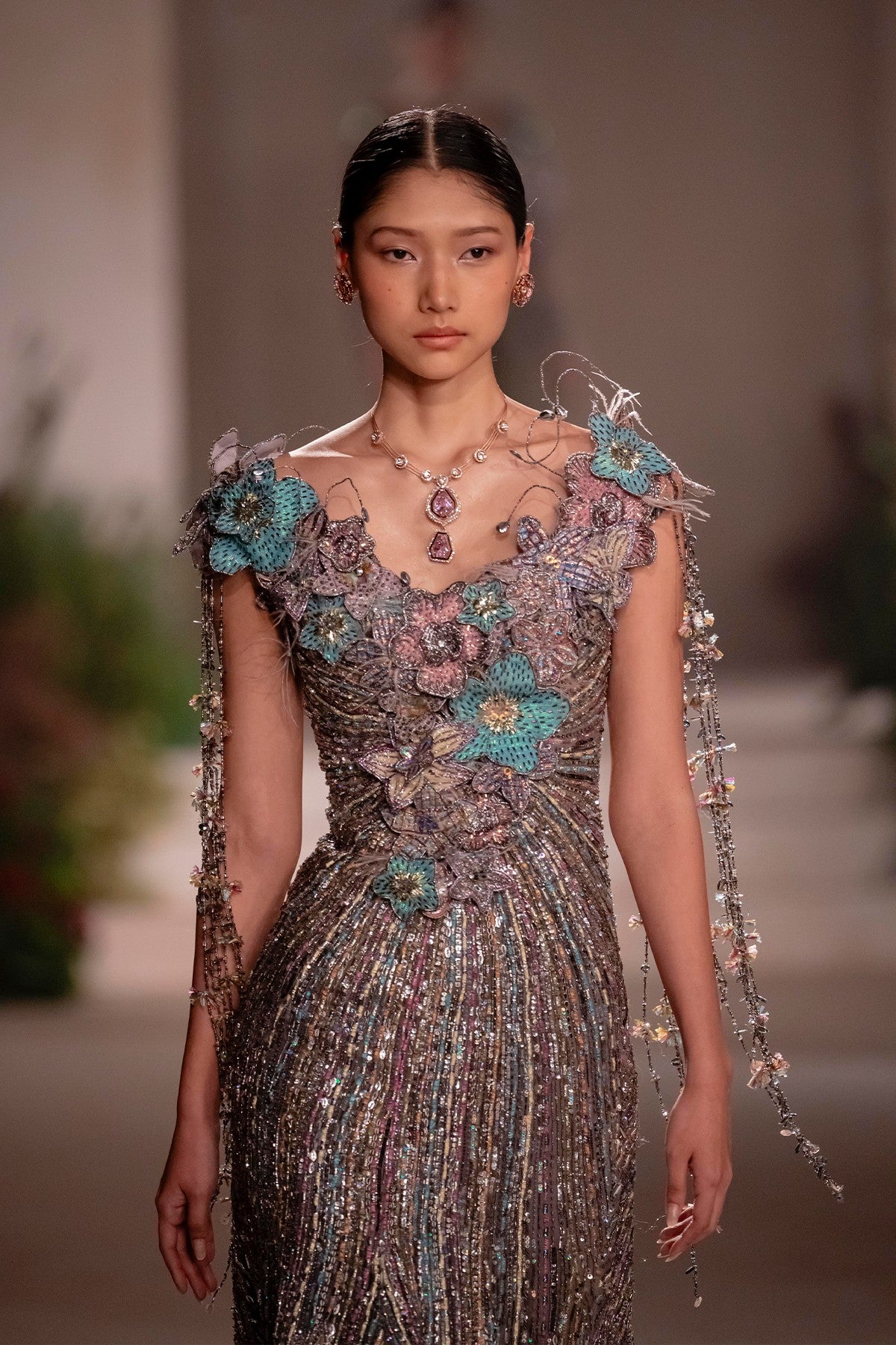 Front view of the grey organza fishtail gown showcasing beaded embellishment and delicate 3D floral appliqué