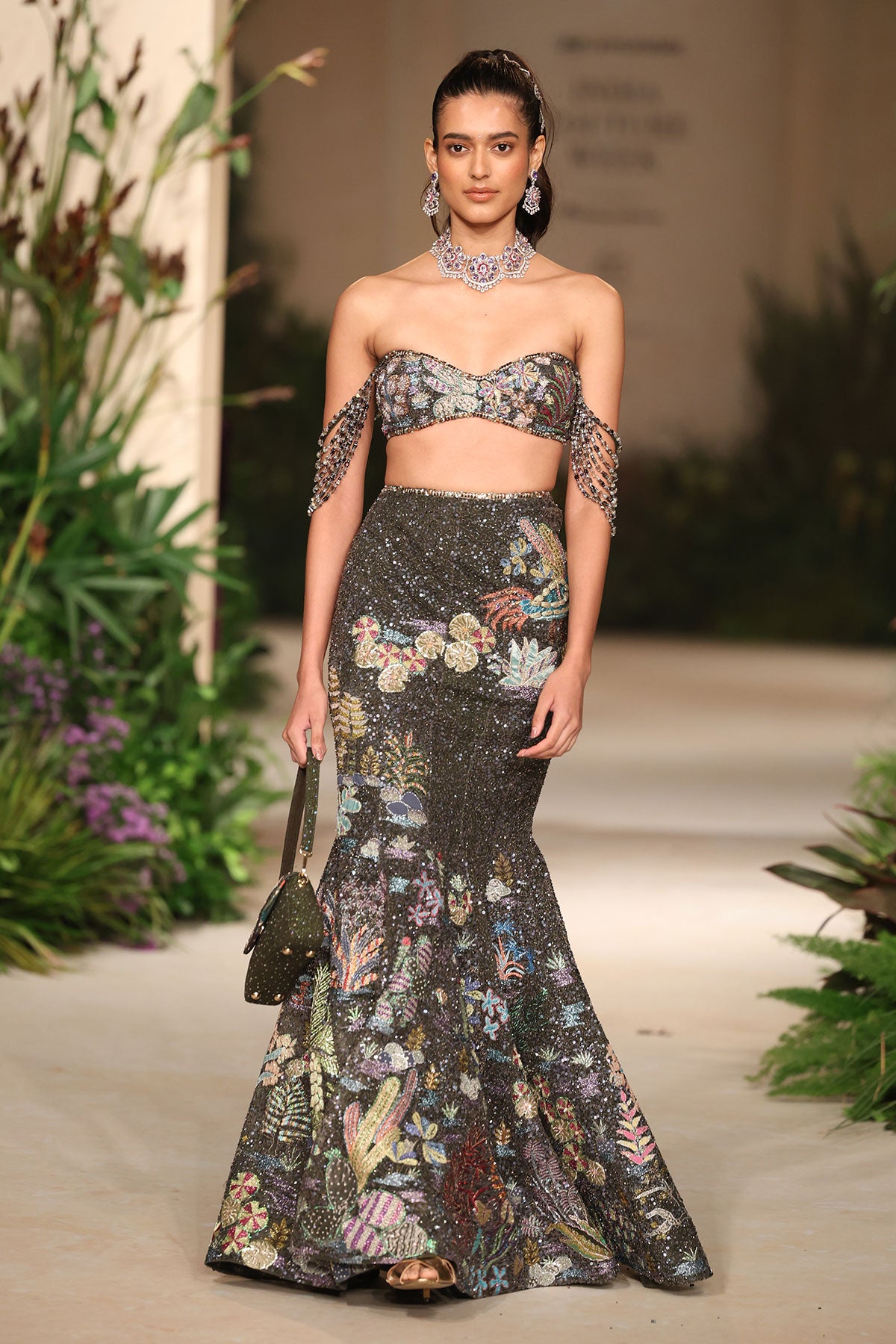 Front view of the gunmetal applique embellished tulle mermaid lehenga highlighting the crystal fringes and bead detailing