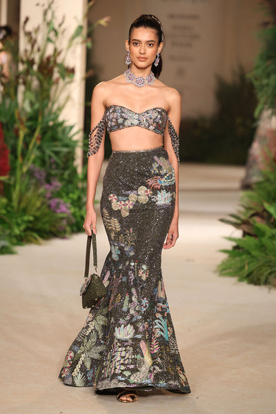 Lehenga captured in motion showing the luminous tulle, applique layering, and embellished sparkle