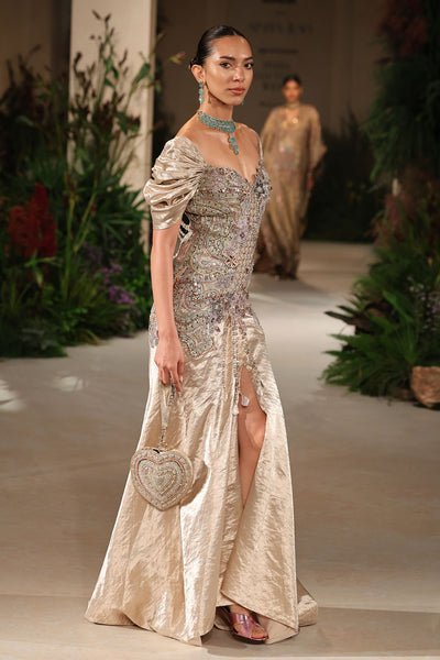 Side profile revealing the Wild At Heart light gold brocade gown’s puffed sleeves and couture applique accents