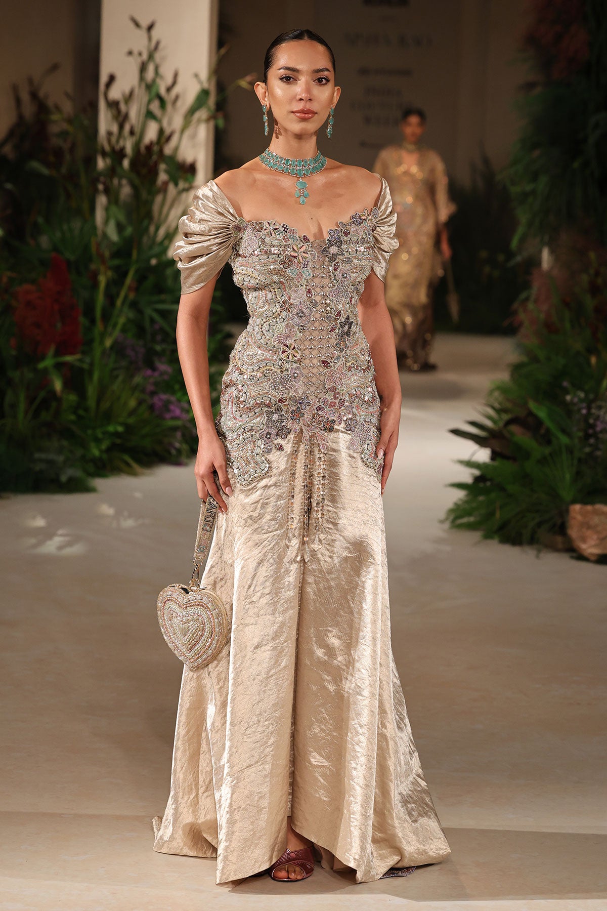 Closeup of the puffed sleeve showing embellished applique on the Wild At Heart light gold brocade gown
