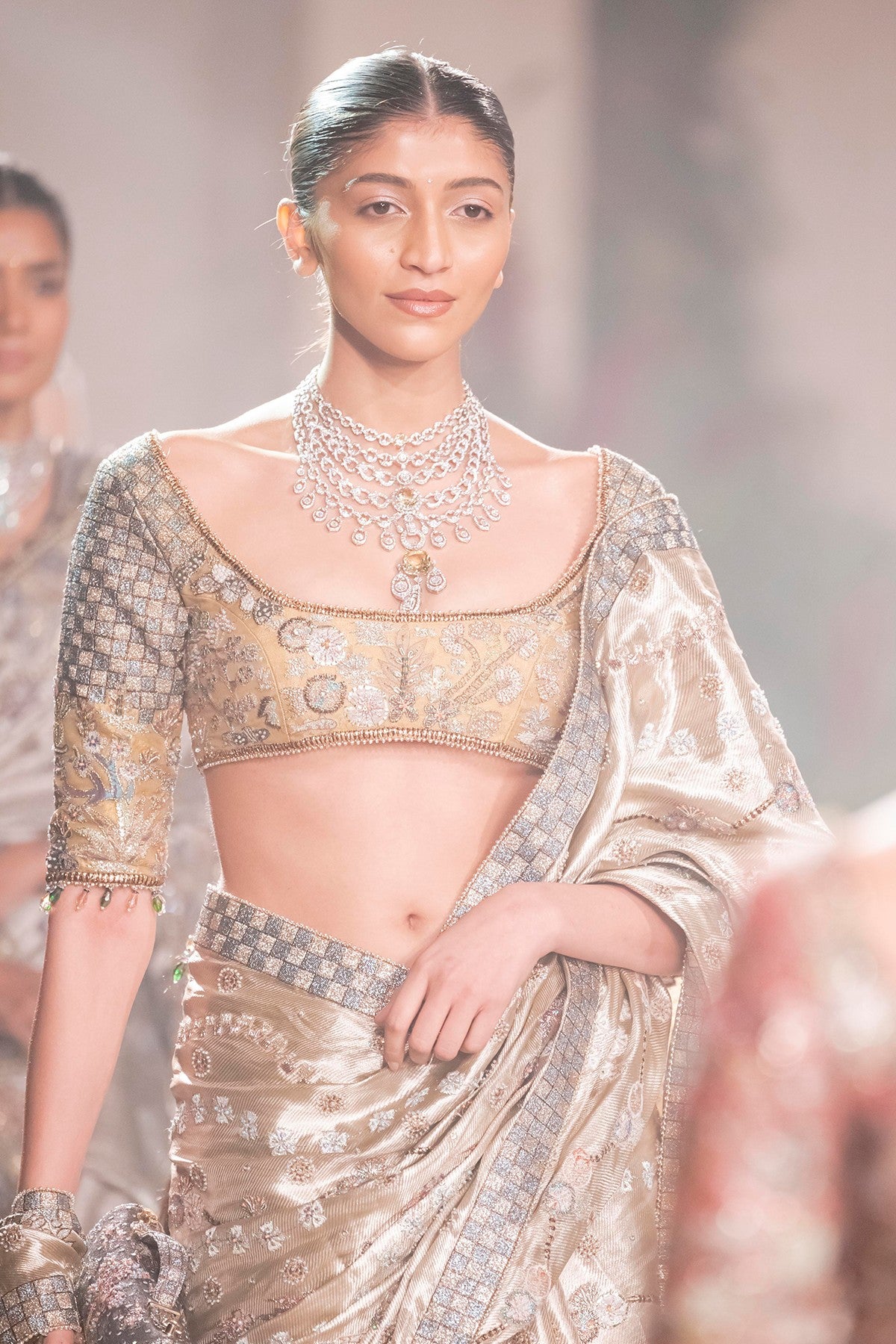 Side profile of the Wild At Heart light gold banarasi tissue brocade saree with couture applique and embellished accents