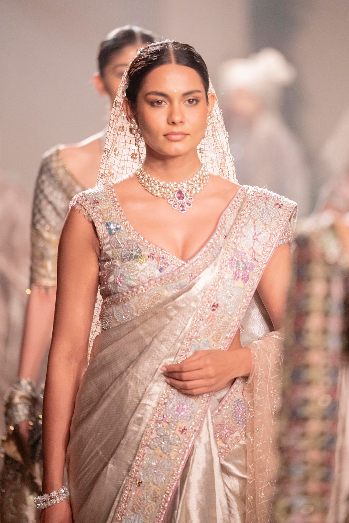 Front drape of the Wild At Heart light gold applique embellished tissue brocade saree highlighting refined detailing