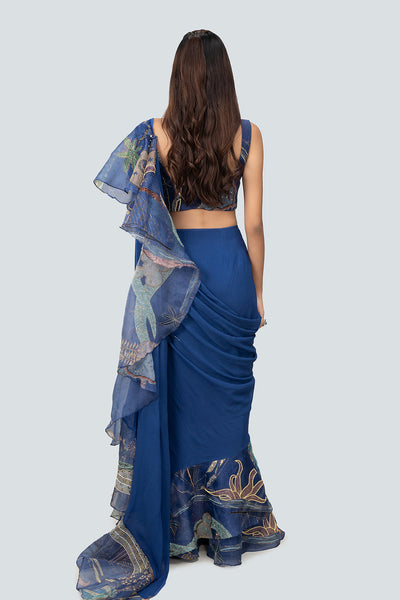 Rear silhouette with flowing ruffle and blouse fit.