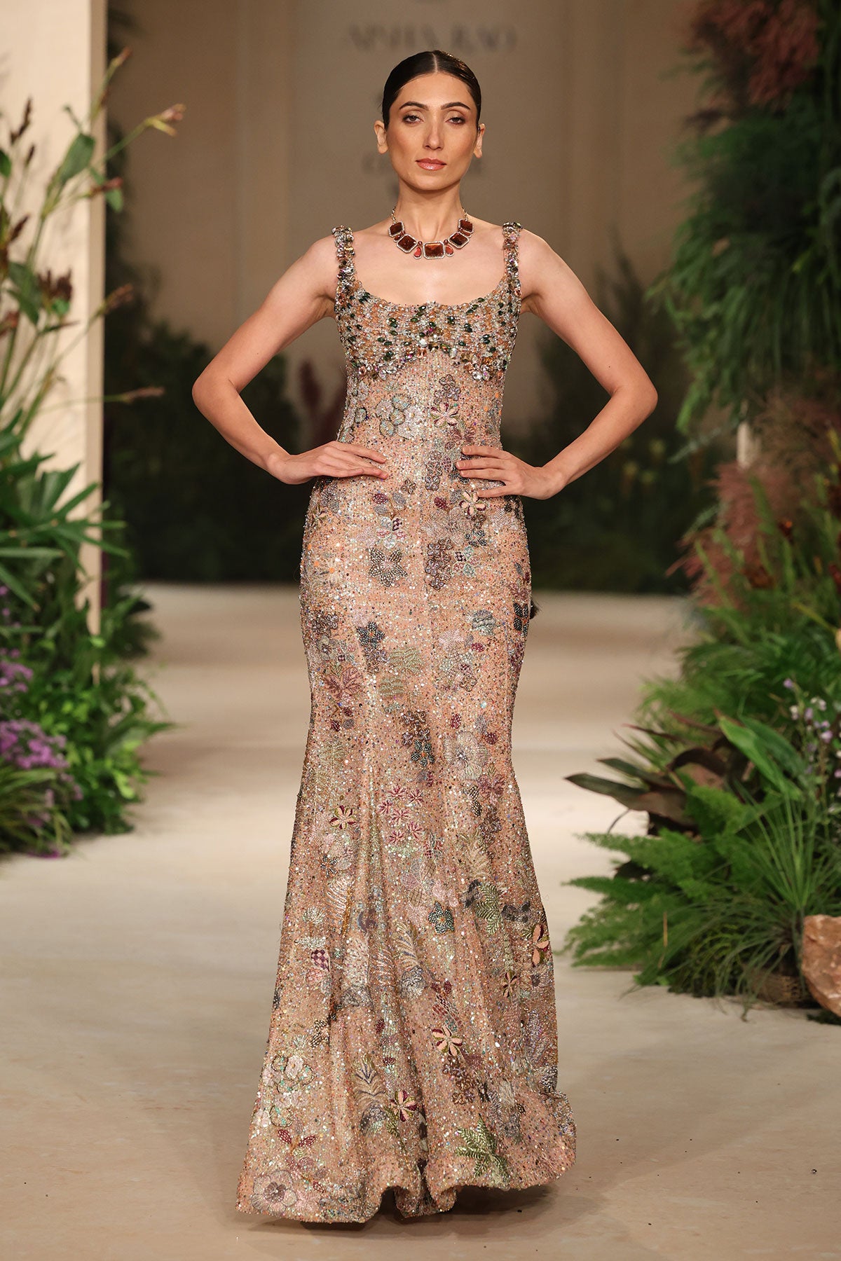 Wild At Heart peach tulle gown captured in motion revealing fluid sequin shimmer and layered applique