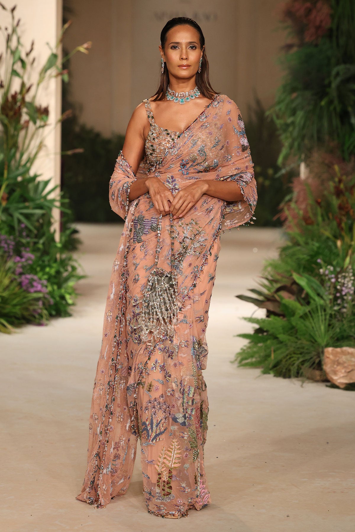 Pleats closeup showing the Wild At Heart peach tulle’s airy drape with applique finishes