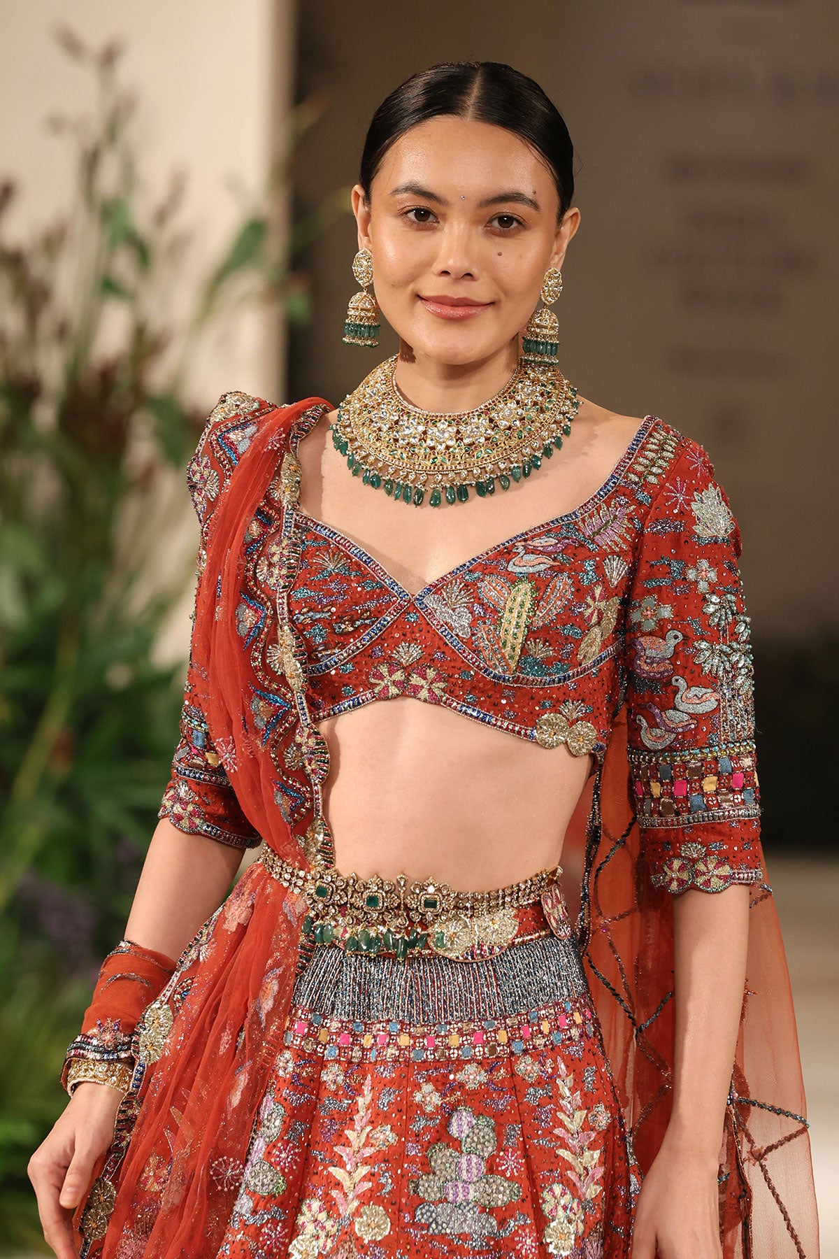 Blouse detailing featuring intricate embellishment complementing the Wild At Heart rust raw silk lehenga
