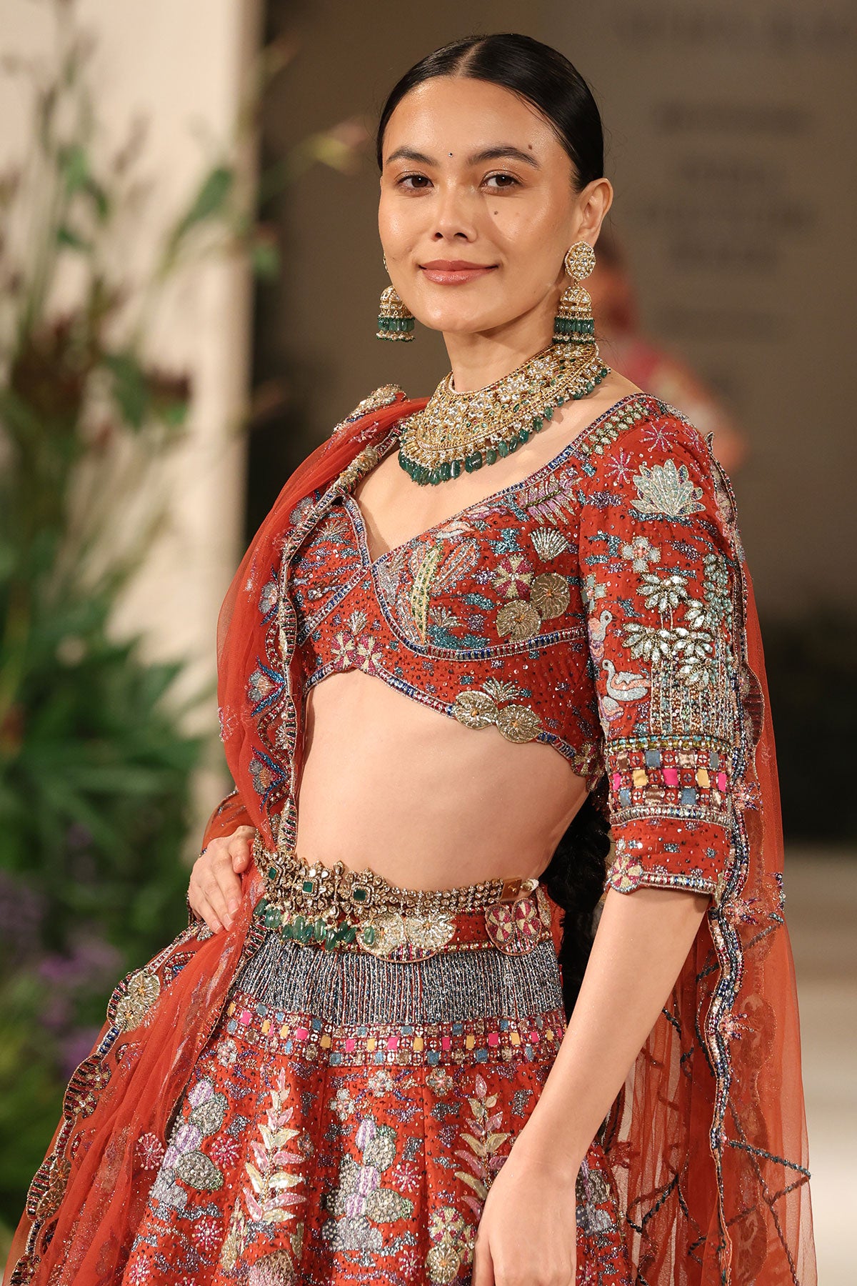 Front view of the blouse paired with the Wild At Heart rust applique embellished raw silk lehenga