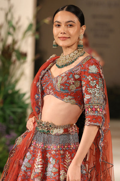 Front view of the blouse paired with the Wild At Heart rust applique embellished raw silk lehenga