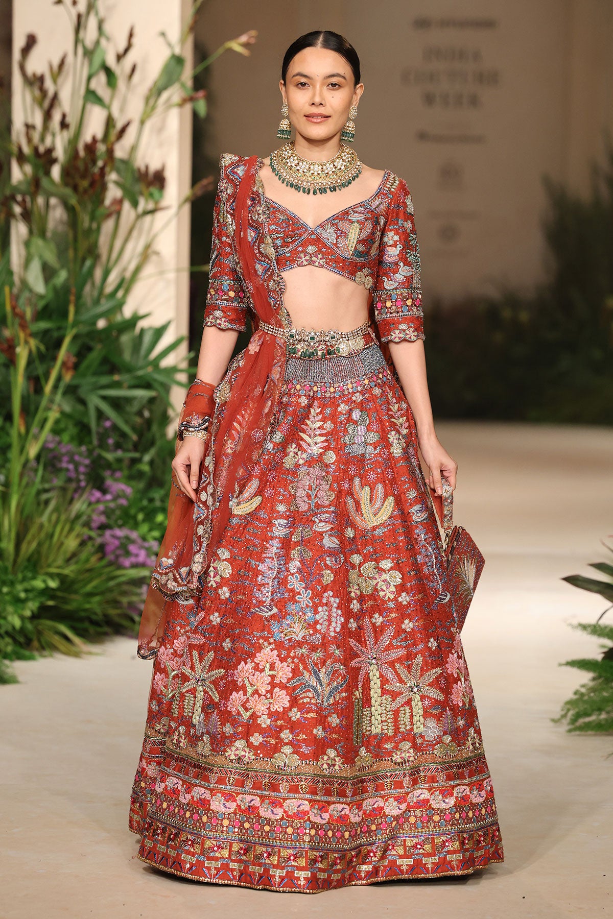 Wild At Heart rust applique embellished raw silk lehenga with blouse and tulle dupatta shown in a full couture view