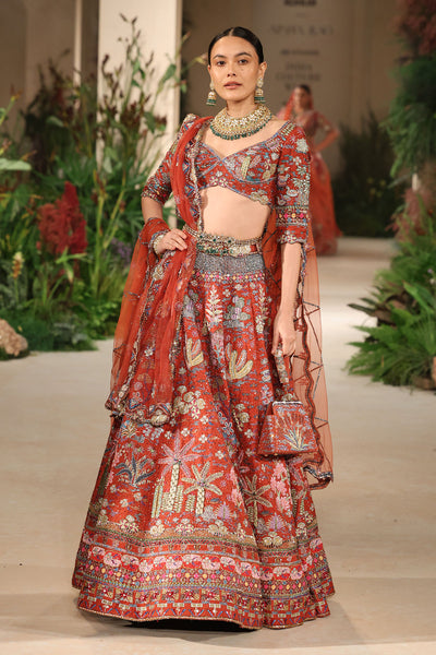 Styled look of the Wild At Heart rust applique embellished raw silk lehenga with blouse and tulle dupatta