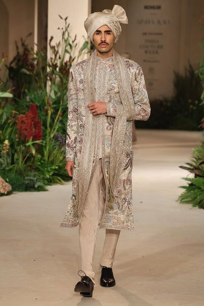Side profile of the Wild At Heart sandstone brocade sherwani revealing layered applique embellishment