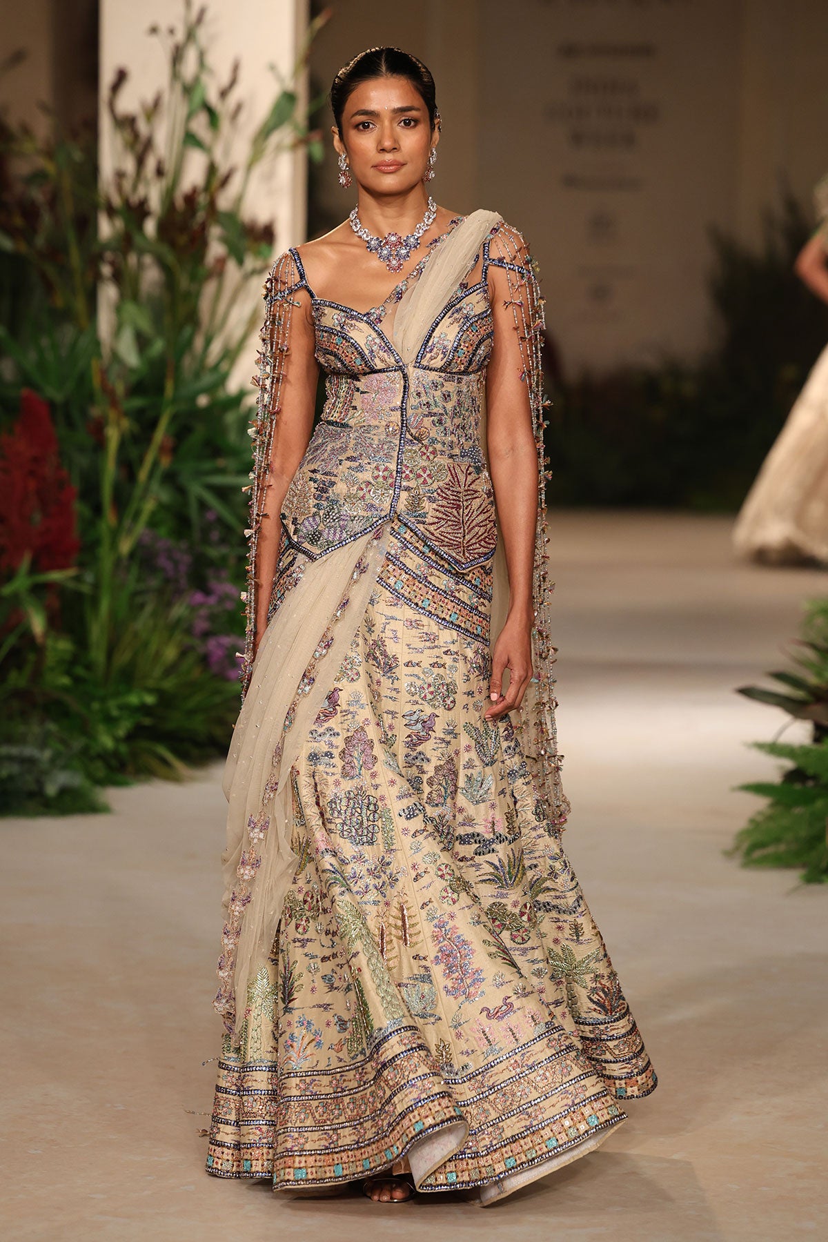 Wild At Heart sandstone raw silk lehenga captured in motion revealing fluid silk movement and layered applique