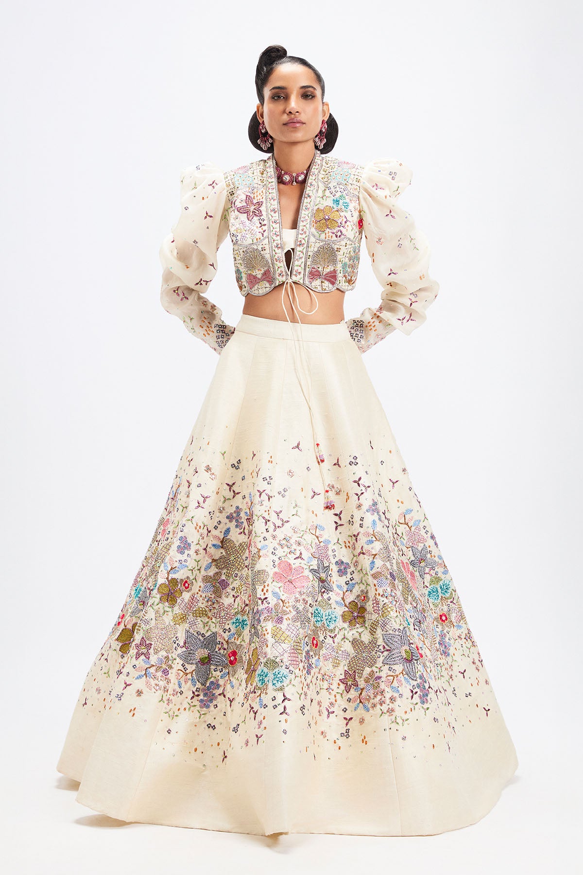 Woman wearing Aisha Rao ivory applique lehenga with jacket