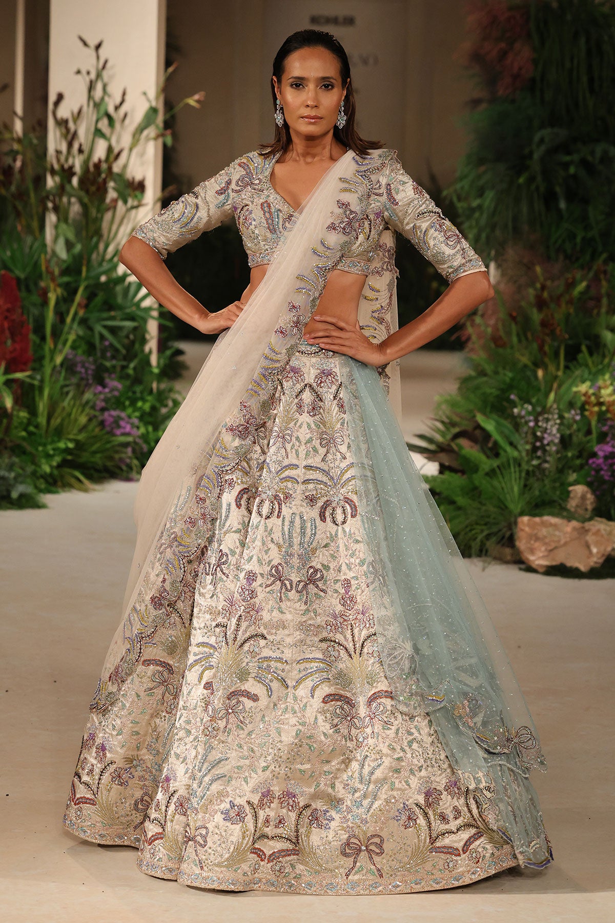 Front view of the Wild At Heart silver bow hk lehenga showcasing applique detailing and the paired blouse with ivory tulle dupatta