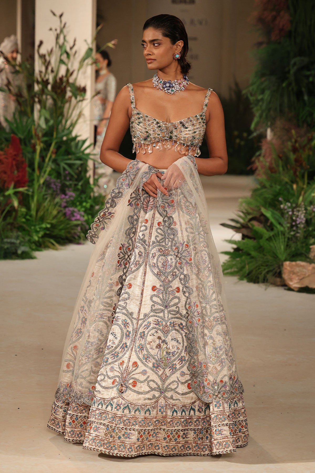 Front view of the crystal blouse paired with the Wild At Heart silver banarasi tissue brocade heart lehenga