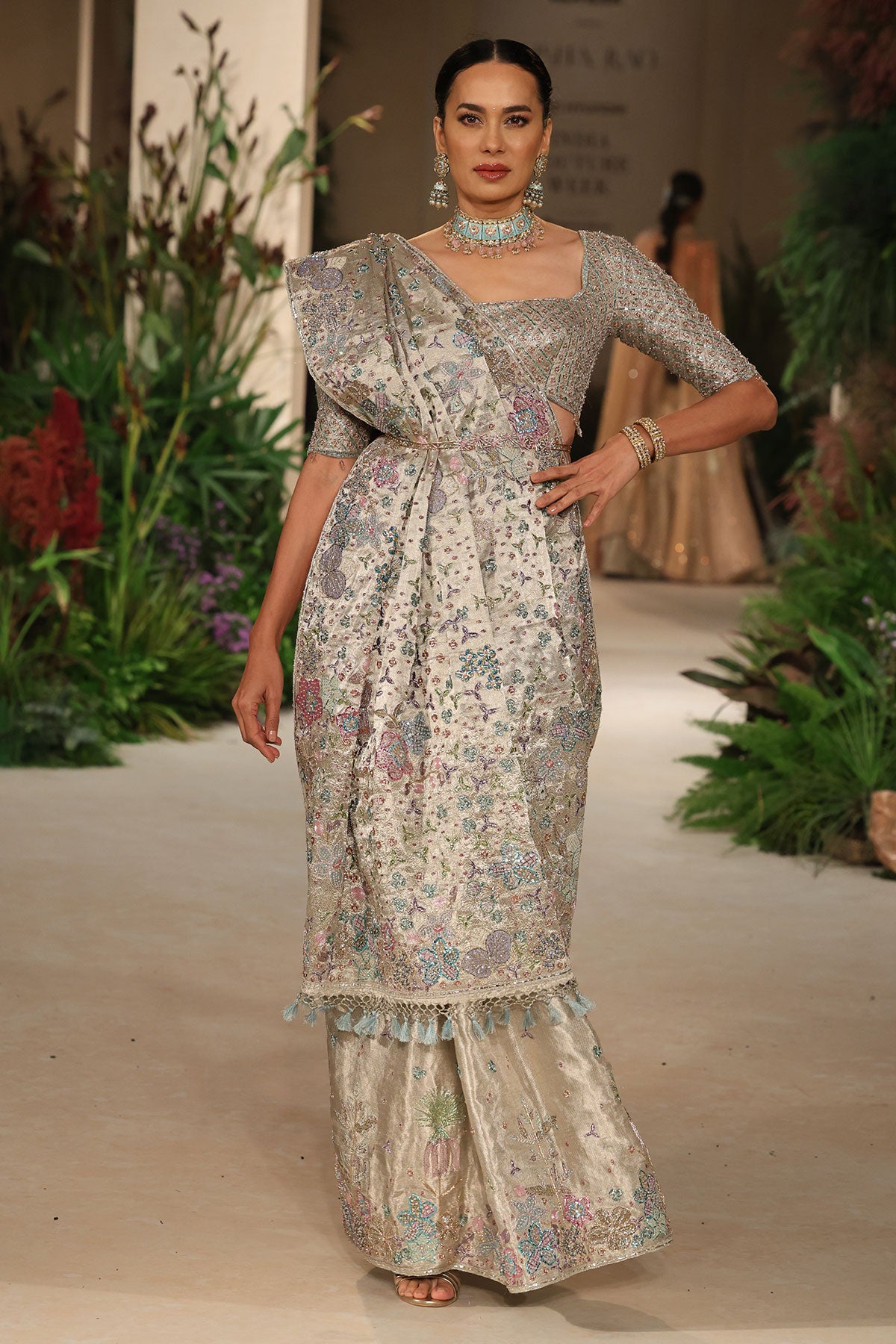 Full view of the silver applique embellished banarasi tissue brocade saree paired with the check blouse
