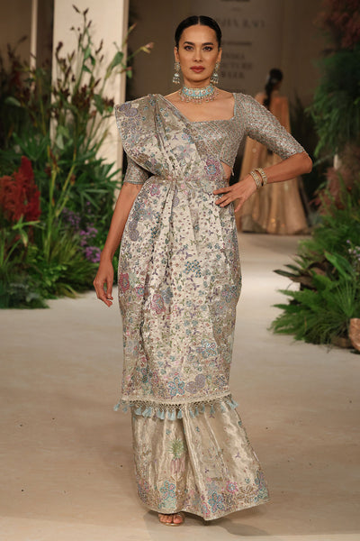 Full view of the silver applique embellished banarasi tissue brocade saree paired with the check blouse