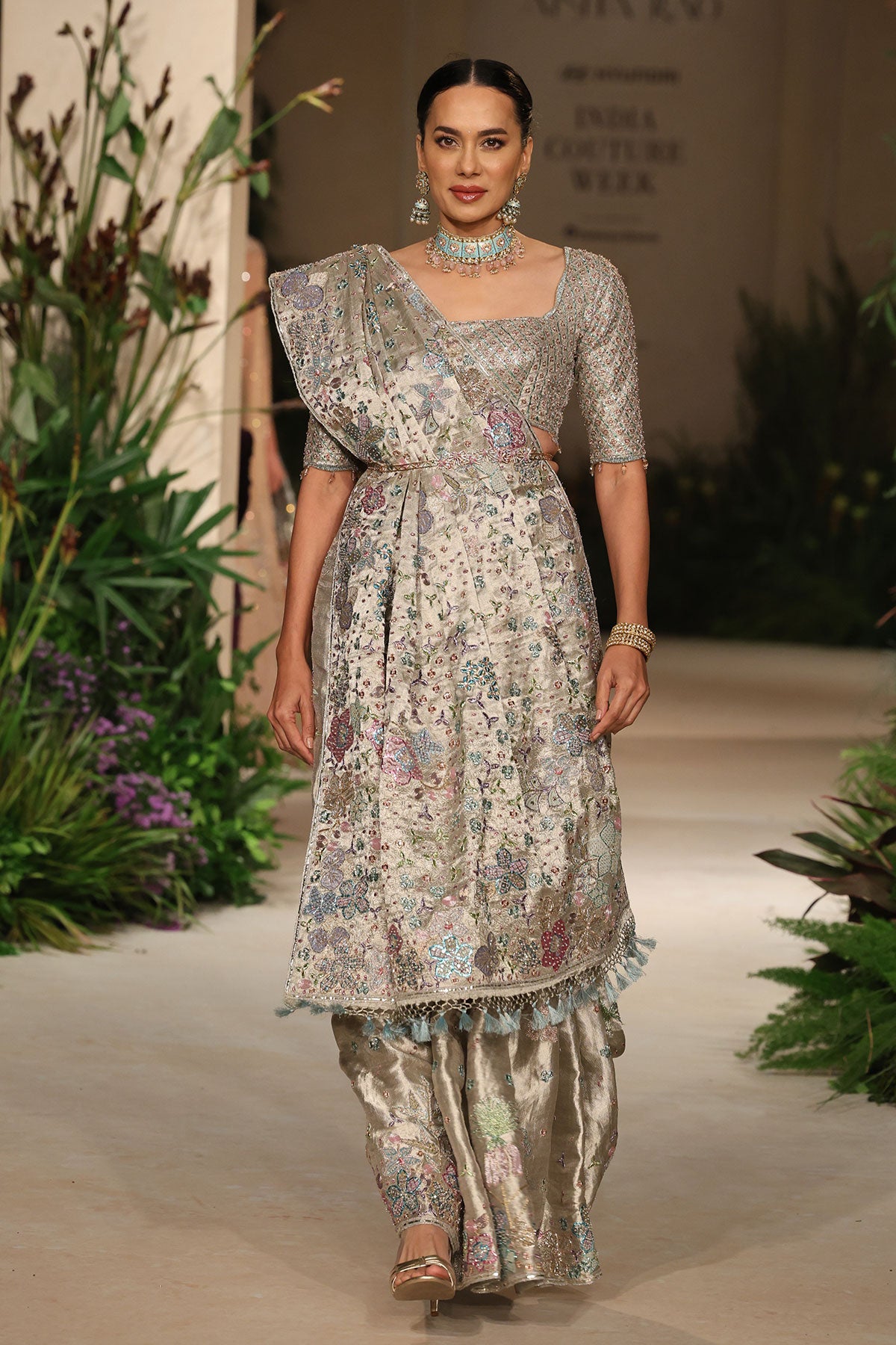 Styled look featuring the applique embellished silver banarasi brocade saree with contemporary check blouse