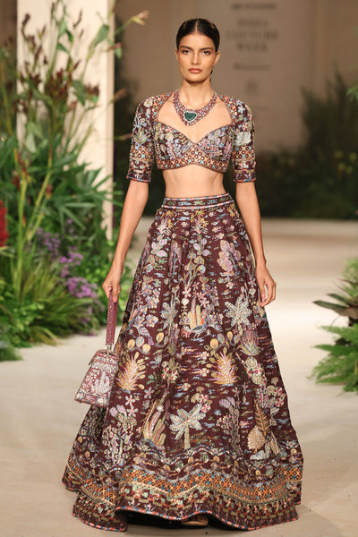 Front close frame emphasizing applique, silk texture, and embellished richness from the Wild At Heart teakberry lehenga