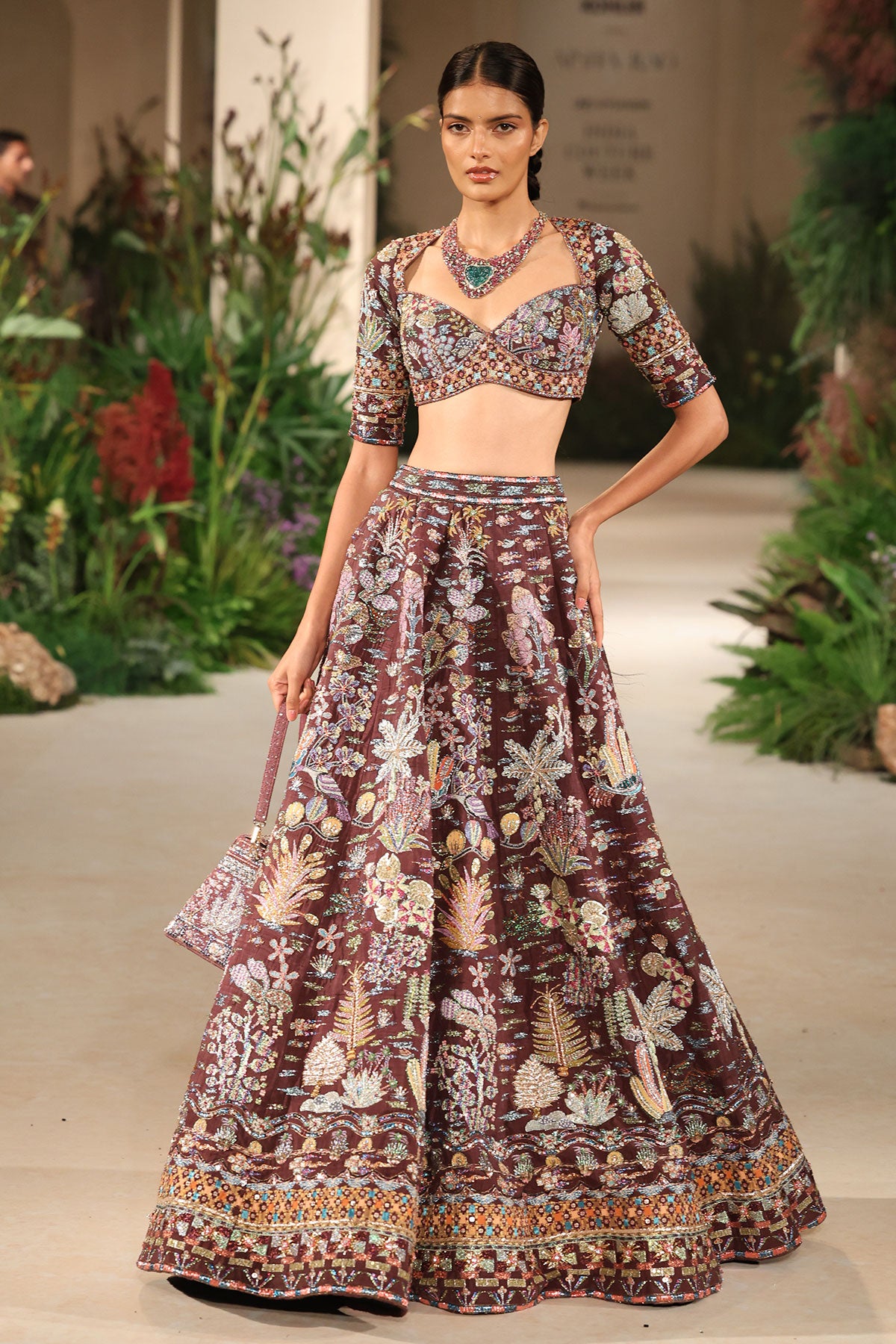 Flowing skirt detail capturing the Wild At Heart teakberry raw silk lehenga’s movement and applique artistry