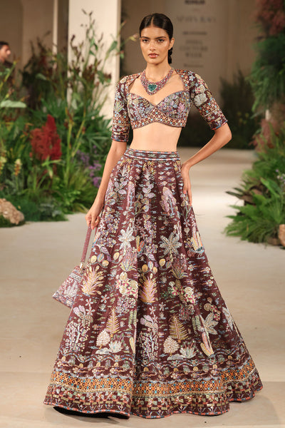 Flowing skirt detail capturing the Wild At Heart teakberry raw silk lehenga’s movement and applique artistry