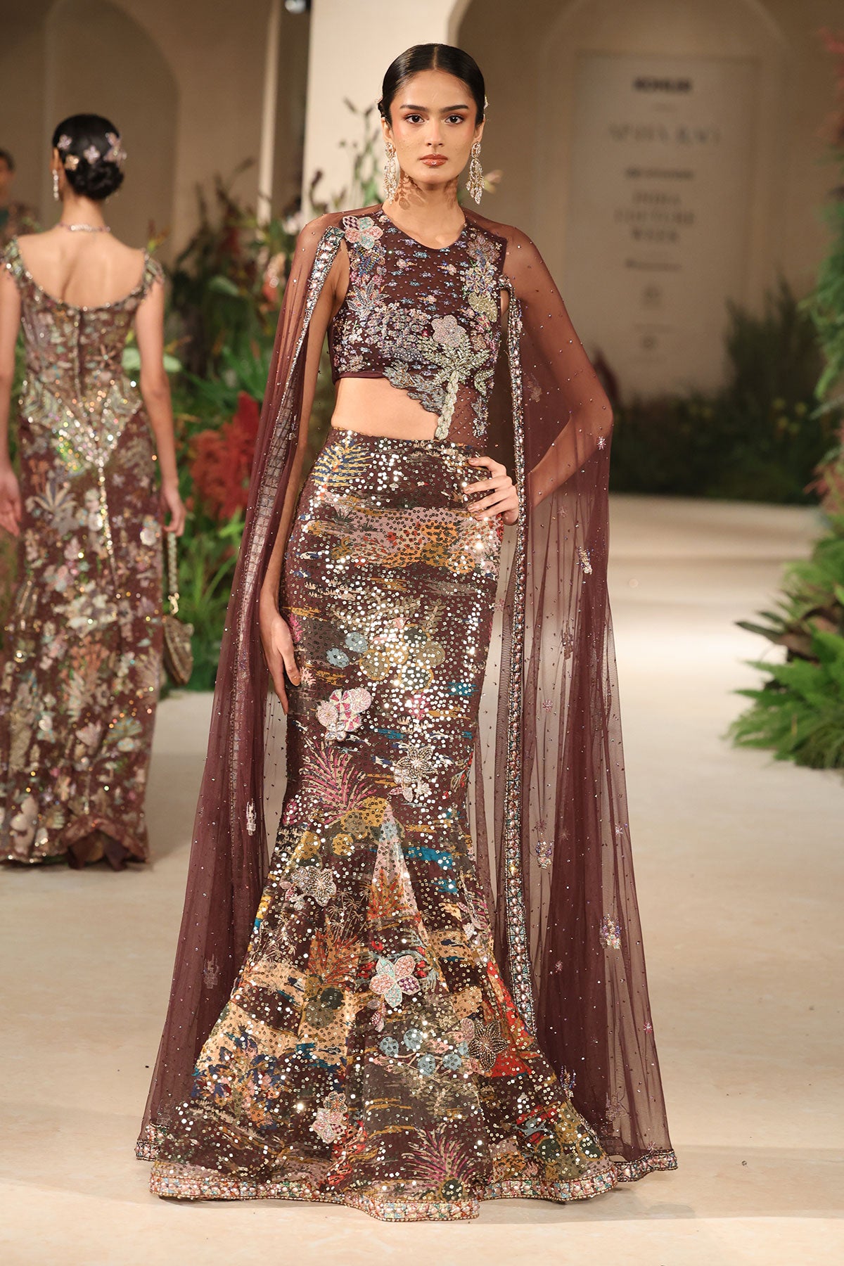 Motion frame showing ethereal cape movement and sequin shimmer from the Wild At Heart gown