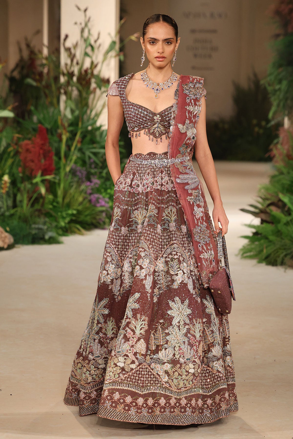 Front view of the Wild At Heart teakberry tulle lehenga highlighting applique craftsmanship and the checked extended blouse