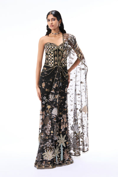 Woman wearing a black tulle drape saree with ornate applique work and structured corset blouse