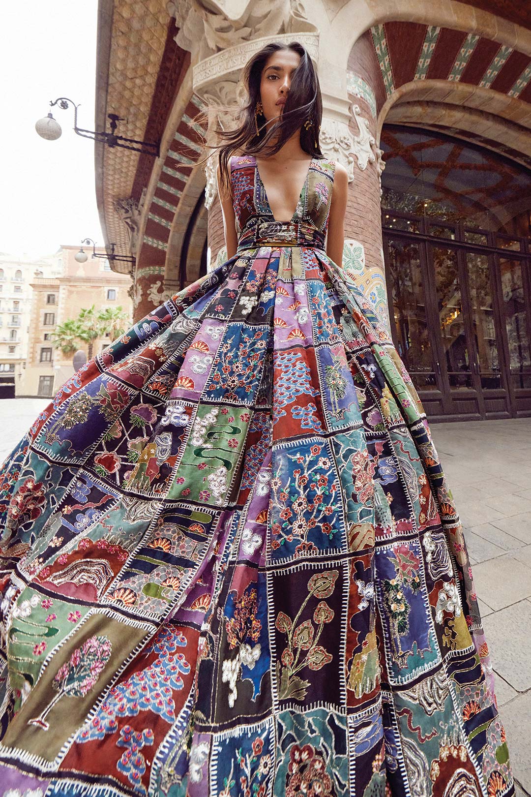 Woman wearing Aisha Rao black frames printed organza gown