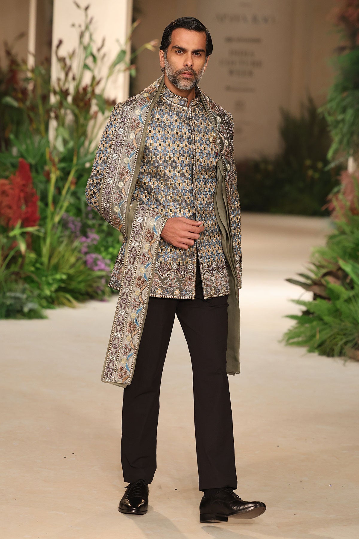 Motion shot capturing the drape of the stole with the tissue bandhgala.