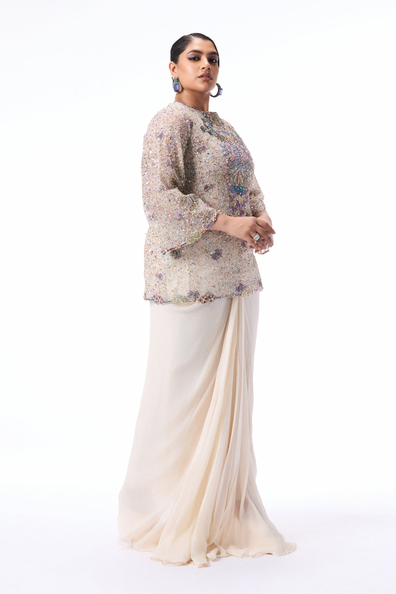 Detail shot of the pleated draped skirt paired with the ivory tulle kurta.