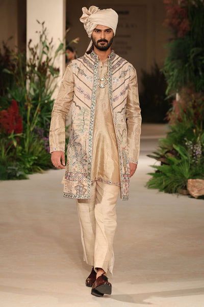 Motion shot showing the natural movement of the sleeveless raw silk long jacket.