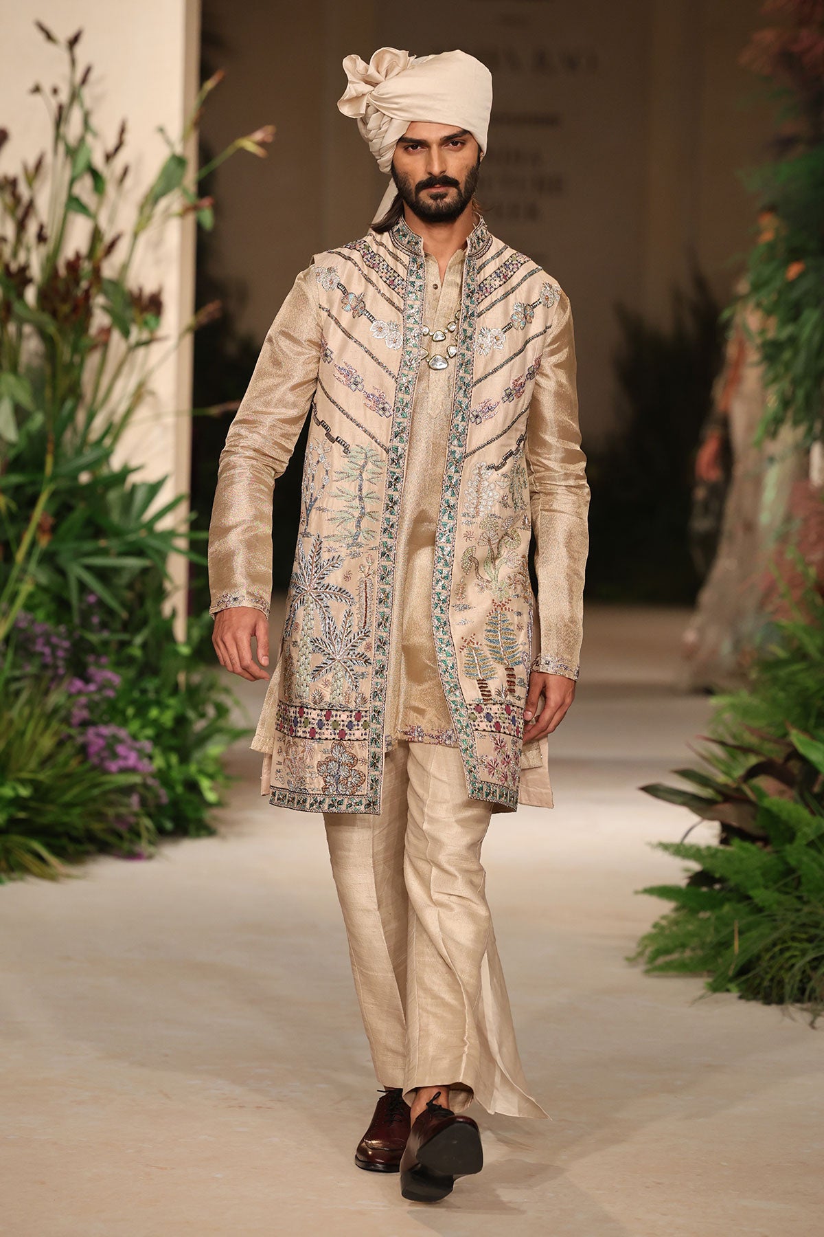 Neckline closeup showcasing applique craftsmanship on the light gold raw silk bundi.